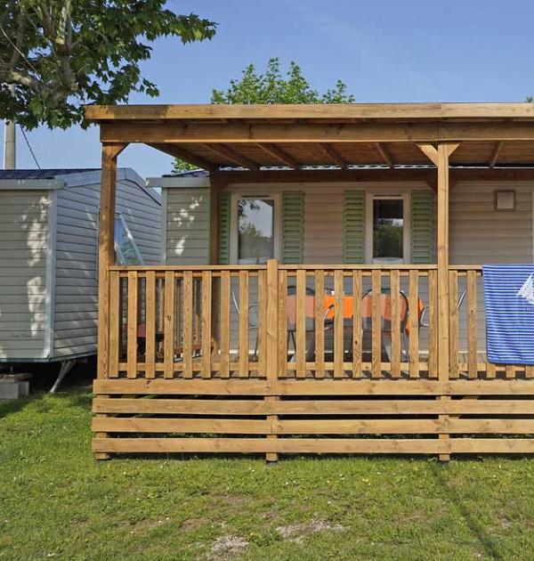 Bungalow en bois avec véranda, idéal pour des vacances en plein air.